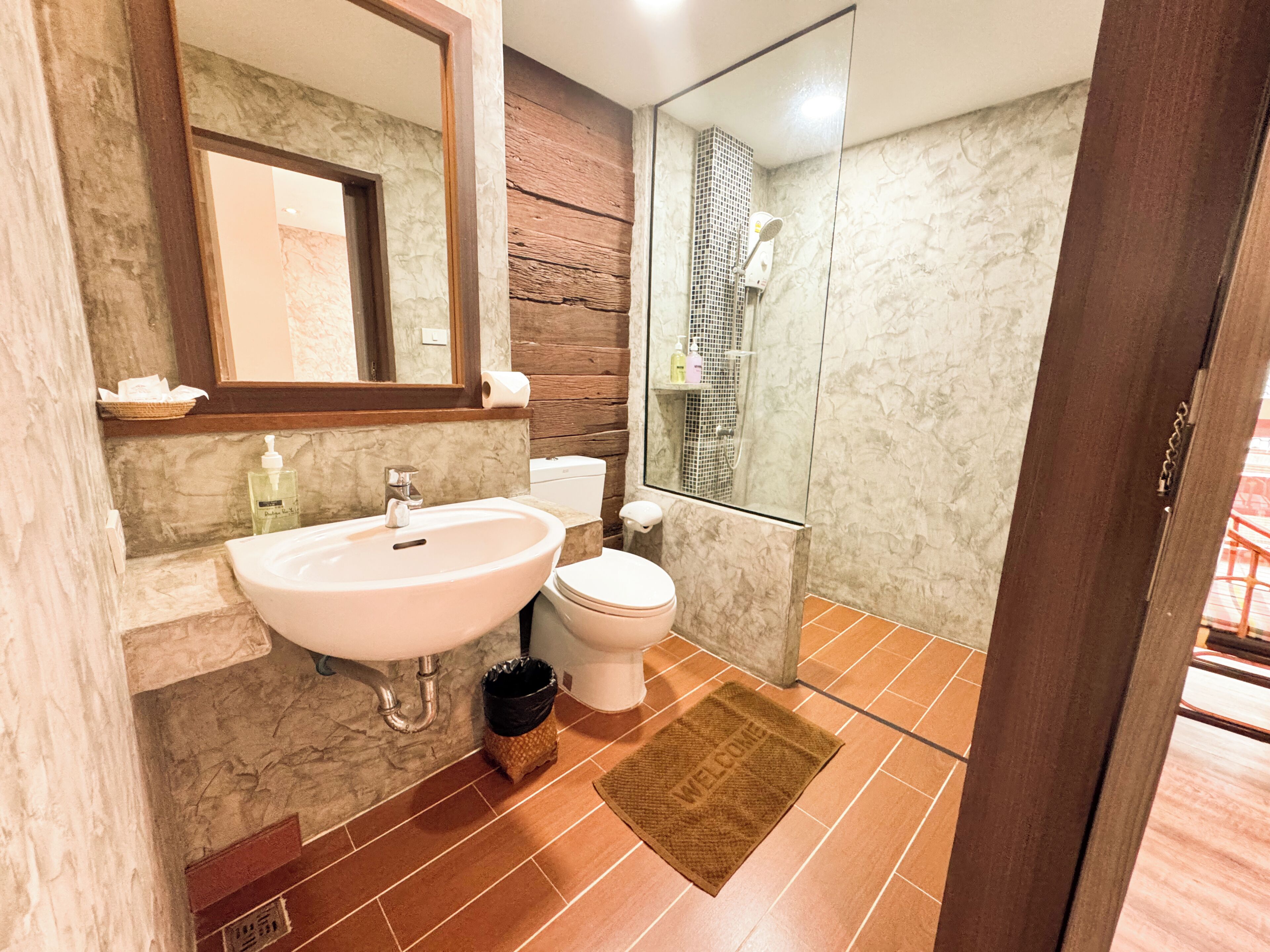 A bathroom with a sink, toilet, and shower.