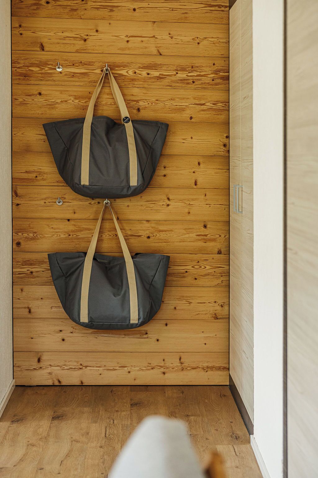 A hallway with wooden walls and a wooden floor.