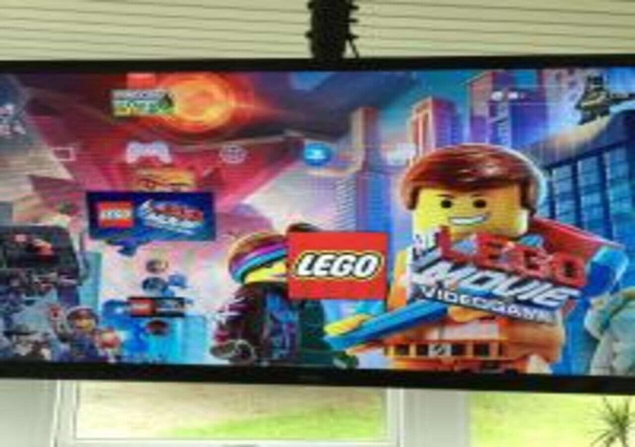 A television displaying a LEGO movie poster.