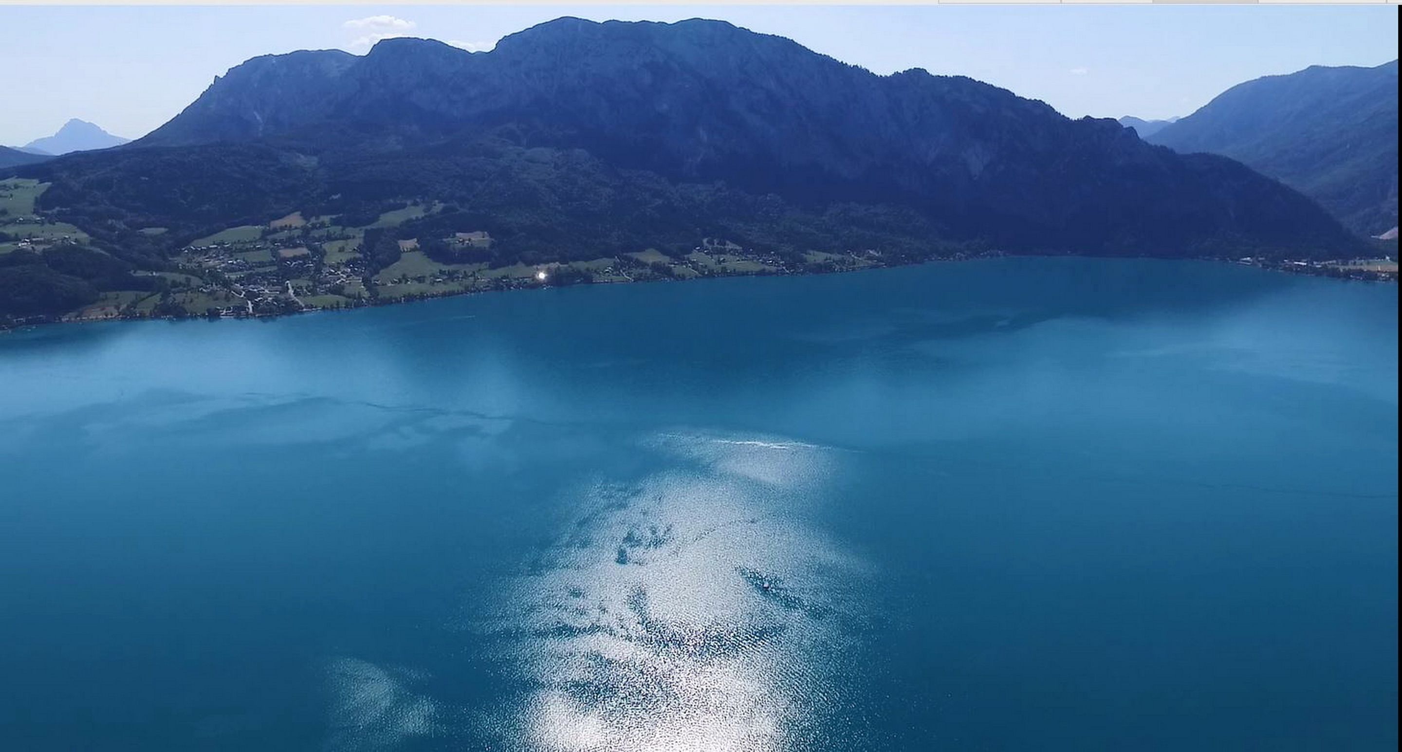 A lake with mountains in the background.