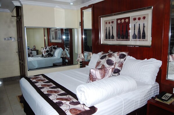 Suite | Living area | 32-inch flat-screen TV with satellite channels, TV, fireplace - Don Suite Hotel (Dar es Salaam)
