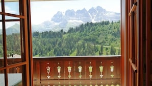 A balcony with a view of a mountainous landscape.