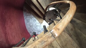 Un escalier en colimaçon avec des marches en bois et une rampe métallique.