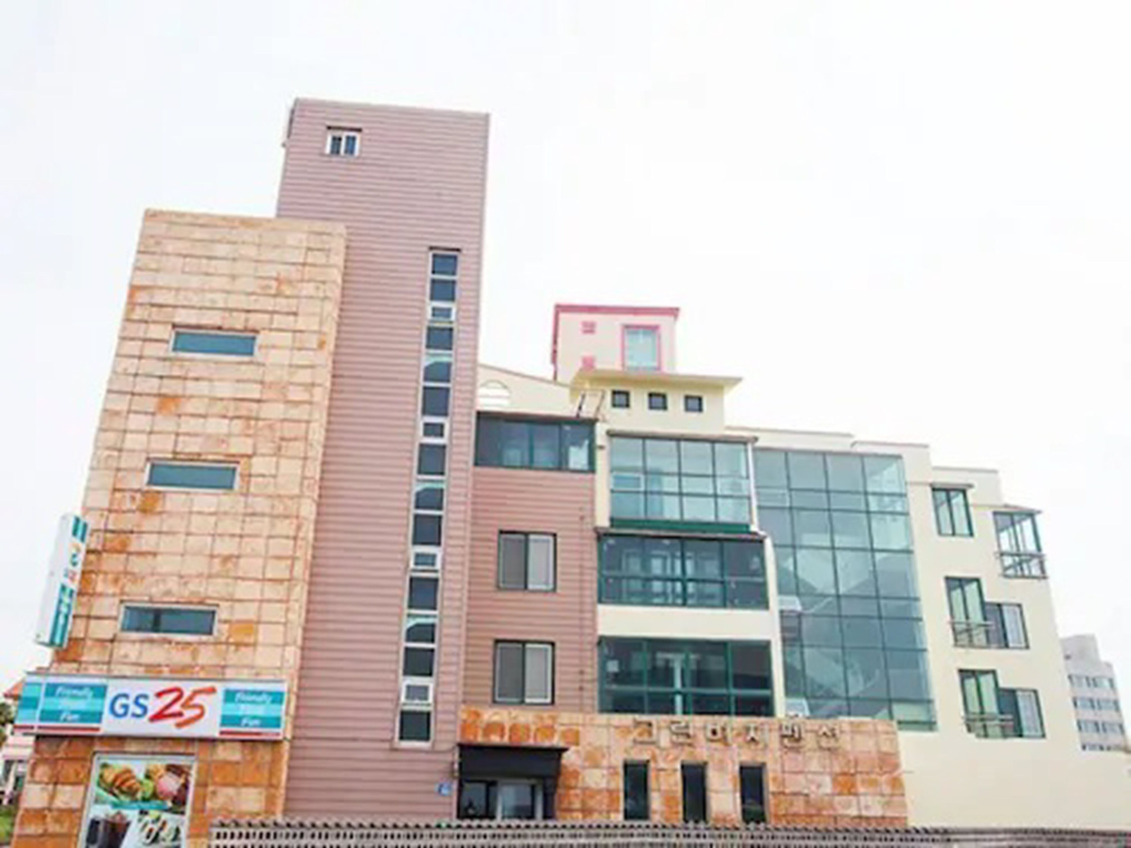 A multi-story building with a mix of brick and glass facades.