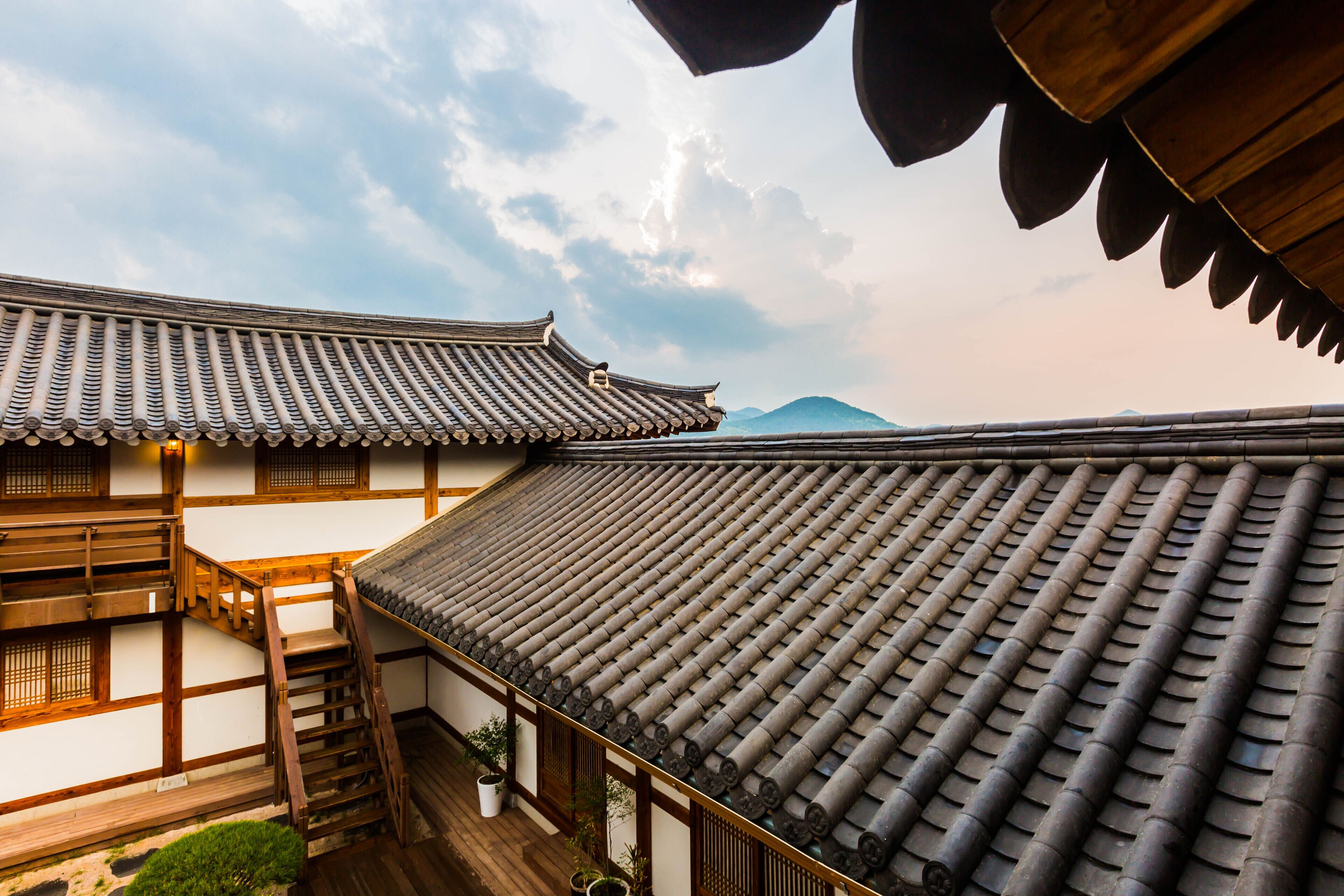 A traditional Japanese building with a tiled roof and wooden structures.