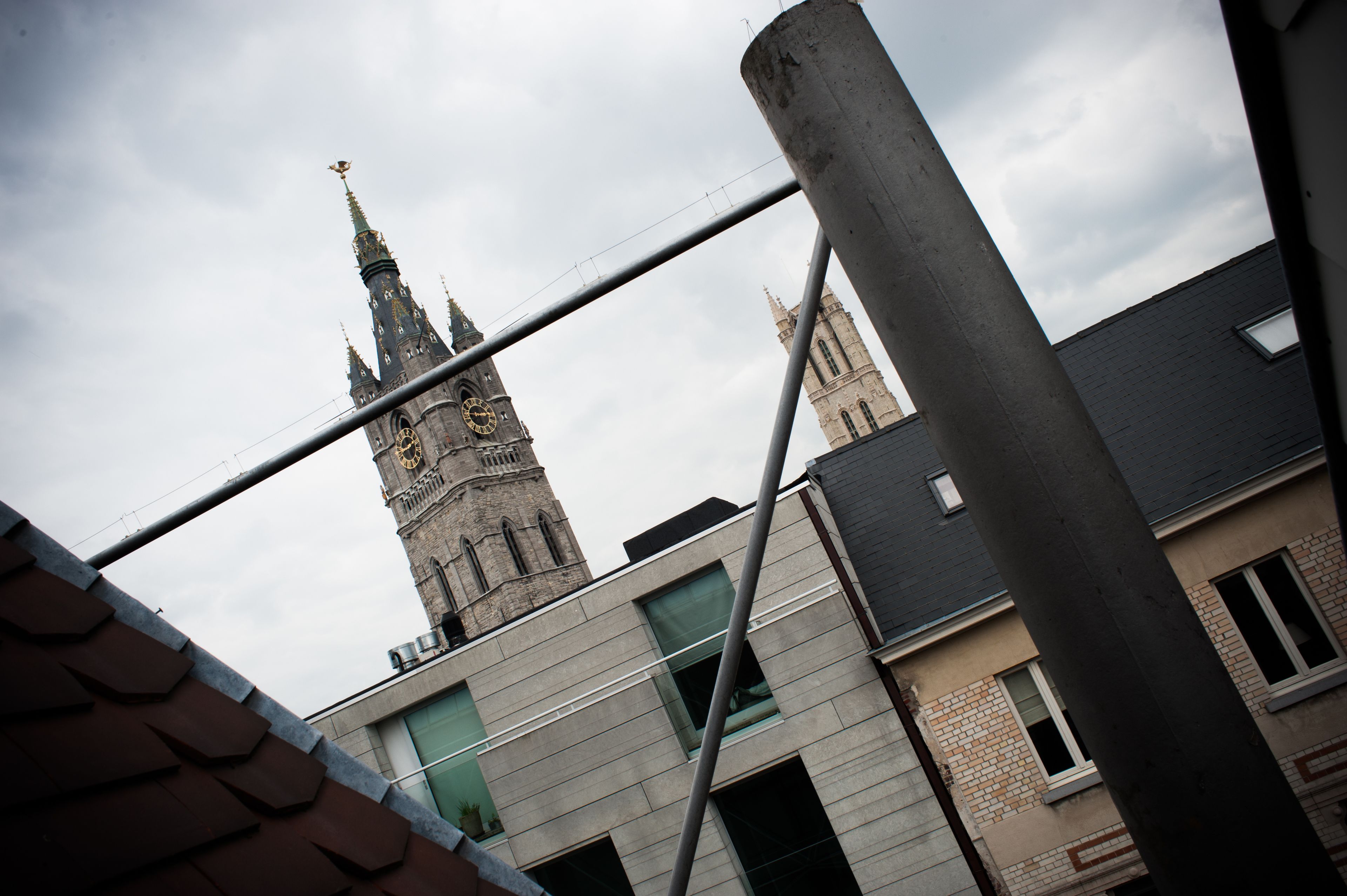A view of a historic clock tower and modern buildings.