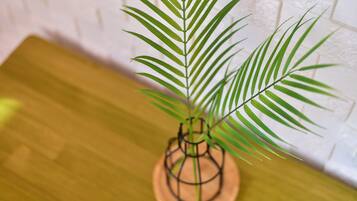 A potted plant with long green leaves on a wooden surface.