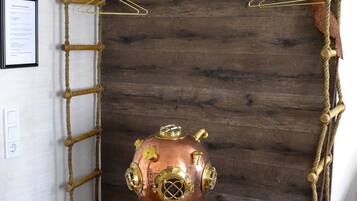 A room with a rope ladder, a copper submarine model, and a wooden chest.