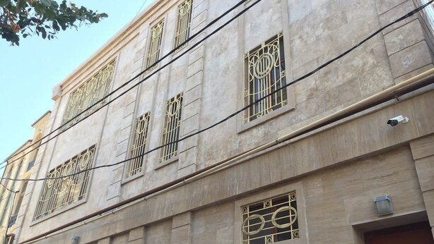 A building with large windows and a garage door.