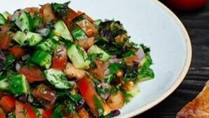 A bowl of fresh salad with various vegetables.