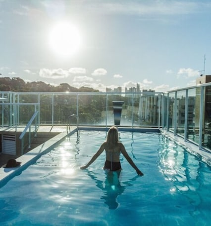 Outdoor pool, pool loungers. Oriental Praia Hotel