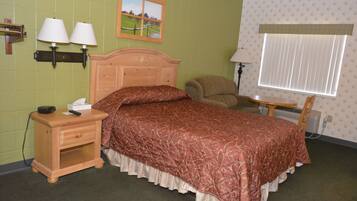 A bedroom with a wooden bed, nightstand, two wall-mounted lamps, a chair, and a window with blinds.