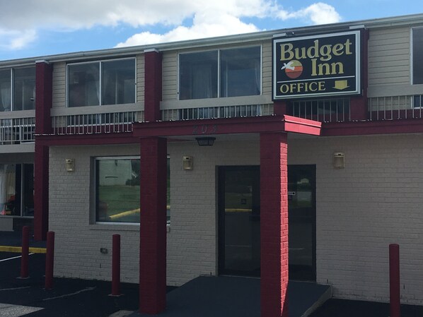 A two-story Budget Inn office building with a red and white exterior, large windows, and a visible entrance. - Budget Inn Tarboro (Tarboro)