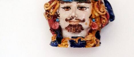 A decorative ceramic piece with a floral pattern and a blue and yellow design.