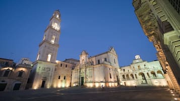 A historic building with a prominent clock tower and a central courtyard.
