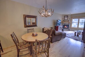 Cozy living room with a fireplace, television, and comfortable seating area, perfect for relaxing and socializing.