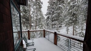 A snow-covered balcony with a wooden railing and a bench. - Starfire 1979 (Keystone)