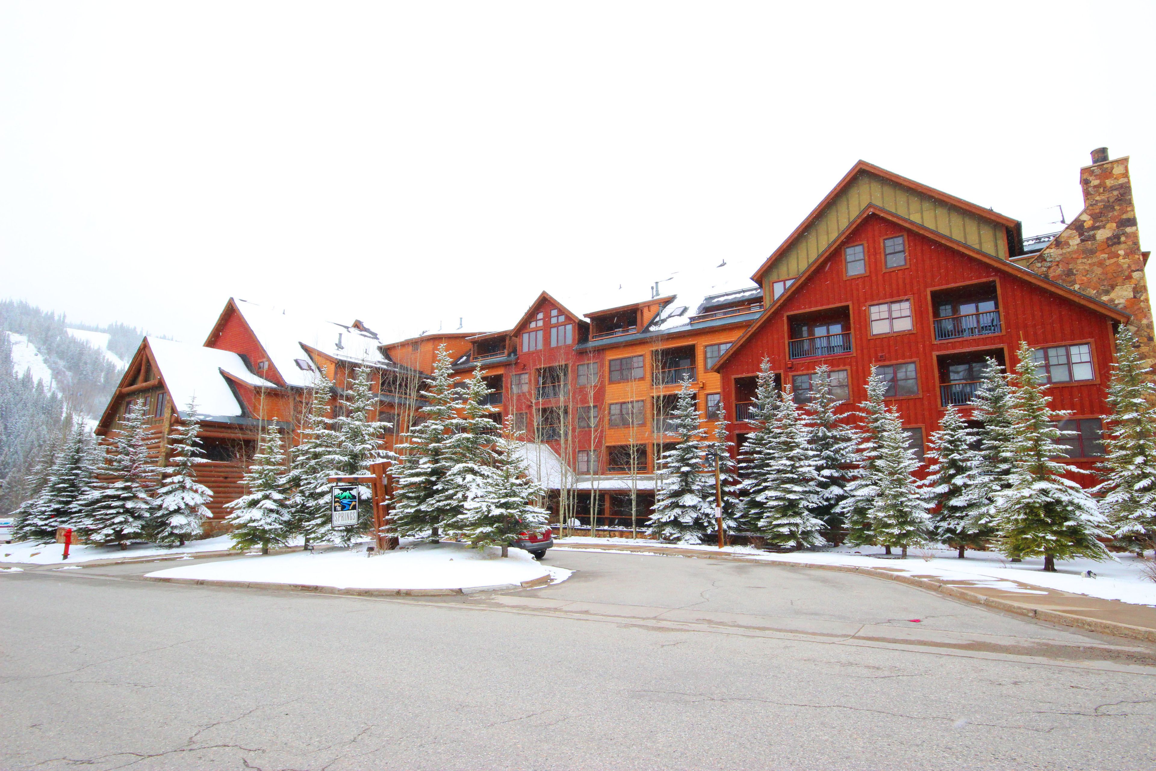 A multi-story lodge with a ski lift visible in the background.
