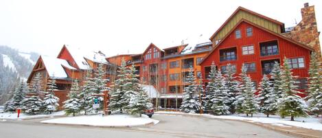 A multi-story lodge with a ski lift visible in the background.