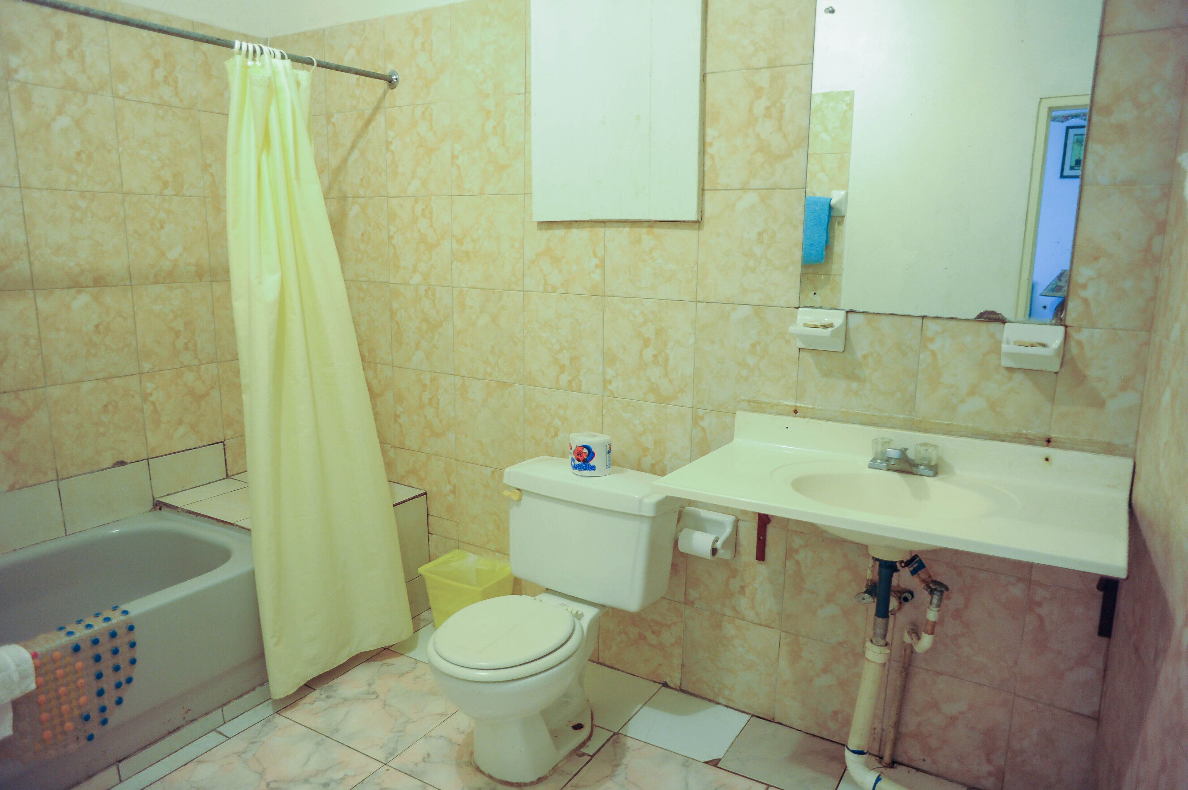A bathroom with a bathtub, toilet, and sink.