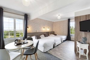 A hotel room with two beds, a dining table, a TV, and a view of the outdoors. - Sure Hotel by Best Western Port Jerome - Le Havre (Port-Jérôme-sur-Seine)