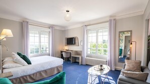 A hotel room with a bed, a desk, a chair, a small table, and a TV. - Sure Hotel by Best Western Port Jerome - Le Havre (Port-Jérôme-sur-Seine)