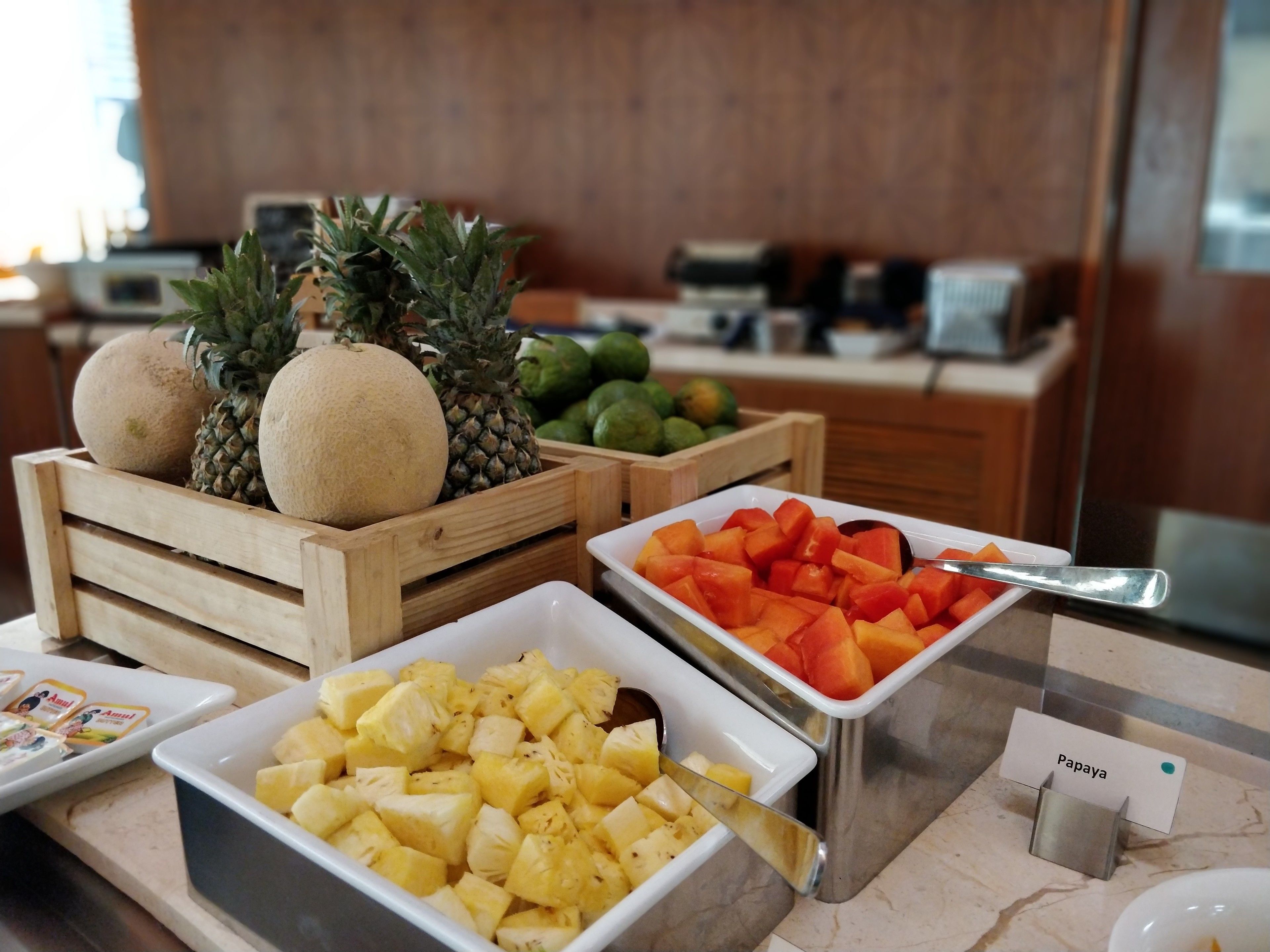 A buffet with various fruits including pineapple, melon, and cantaloupe.