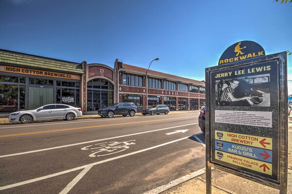 A street view with a sign for Jerry Lee Lewis, a building labeled High Cotton Brewing Co., and a bike lane.