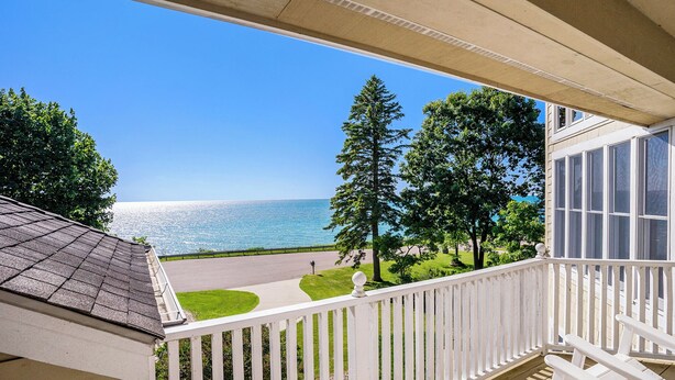 A balcony with a view of the ocean and a road. - Luxury 7BR multifamily on Lake Michigan, Pool & Spa, New Kitchen and Lake Porch! (South Haven)