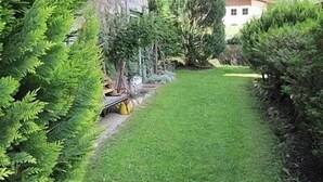 A well-maintained garden with a grassy path leading to a building with a stone facade. - Cosy Apartment In The Center Of Krimml, A Stroll Away From Krimml Waterfalls (Krimml)