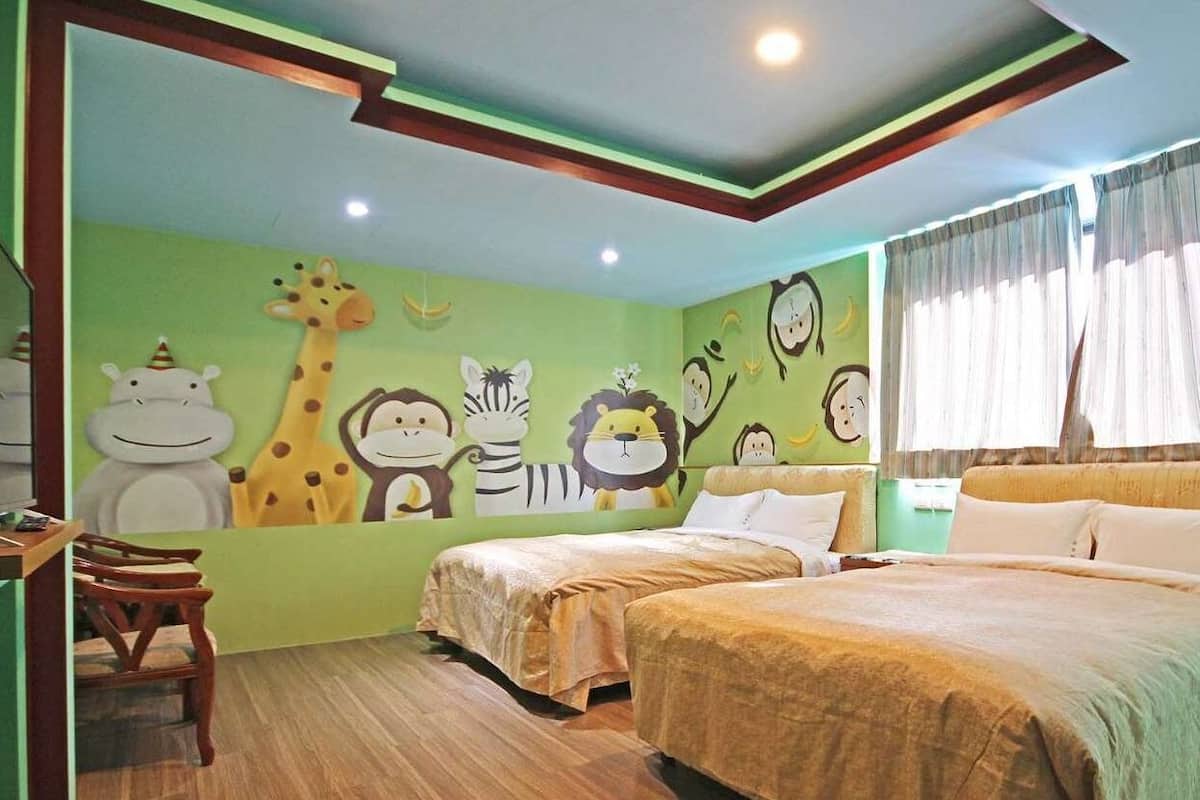 A children's room with two beds, a desk, and a wall decorated with animal murals.