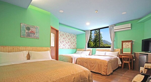 A room with two beds, a window with a view of greenery, a small desk, and a television. - Tan Hsiang Yu B&B (Yuchi)