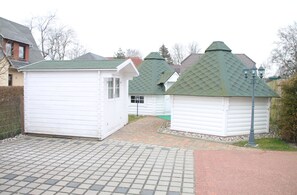 Cozy cabins line a pathway, offering a serene retreat.