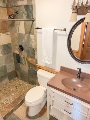 A bathroom with a shower, toilet, sink, and a mirror. - Whistlepunk #4 - Complete Renovation, Truly Slopeside, Near 2 Lifts & Village (Snowshoe)