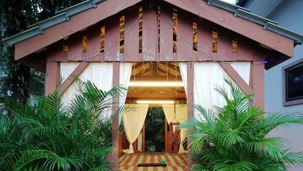 A wooden structure with a sloped roof, a central doorway, and a patterned floor. - ArRayyan Guesthouse & Homestay (Taiping)