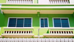 A multi-story building with balconies and large windows. - Natcha Place Rangsit Donmuang (Lam Luk Ka)