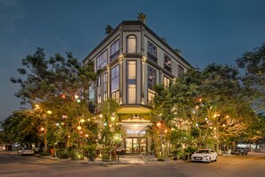 A corner building with a restaurant named "Hoko Restaurant" at the entrance, surrounded by trees and street lamps. - Haka Hotel & Apartment (Da Nang)
