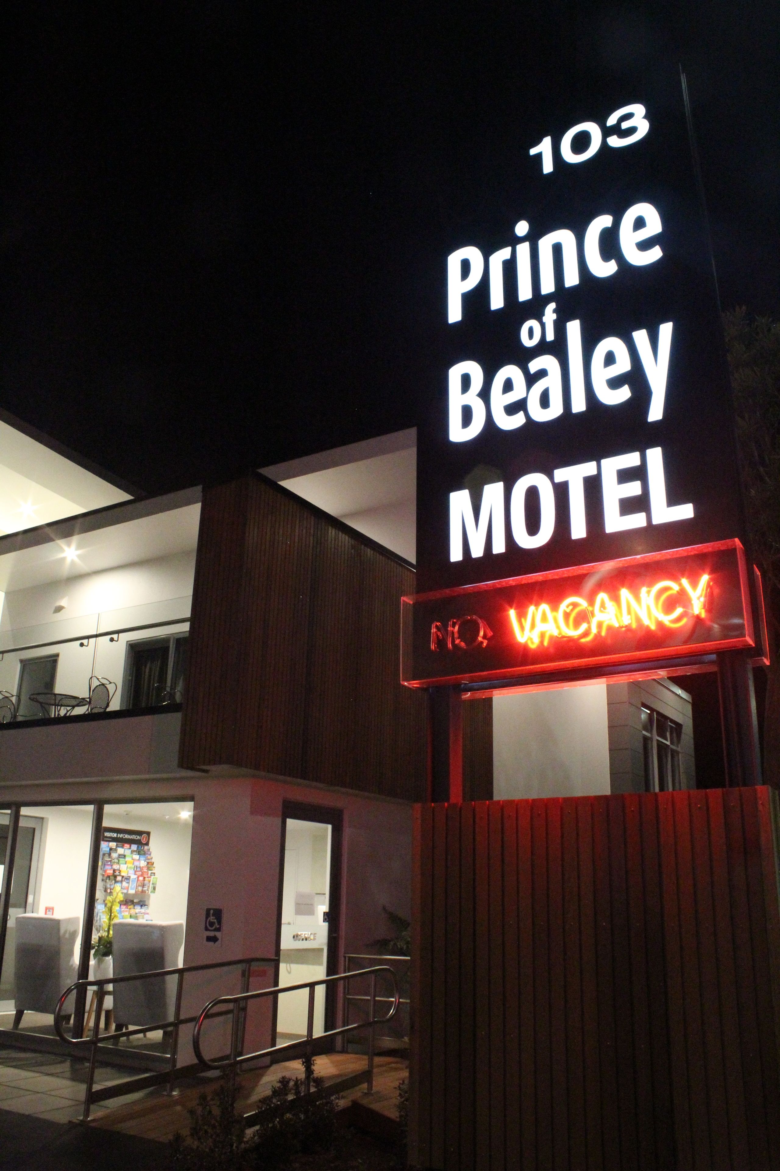 A motel sign with "103 Prince of Bealey" and "No Vacancy" displayed.