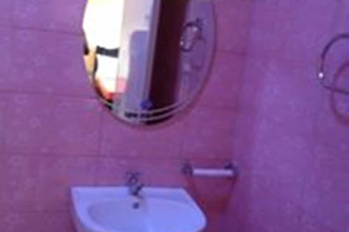 A bathroom with a sink and a mirror.