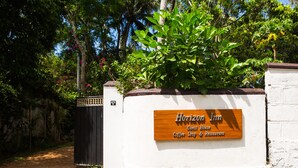 A guest house sign with "Horizon Inn" and "Guest House" written on it, along with a "Coffee Shop & Restaurant" label. - Horizon Inn (Weligama)