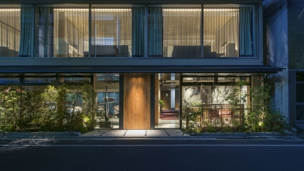 A modern hotel with large windows, a wooden entrance, and a well-lit interior. - Art Mon Zen Kyoto (Kyoto)
