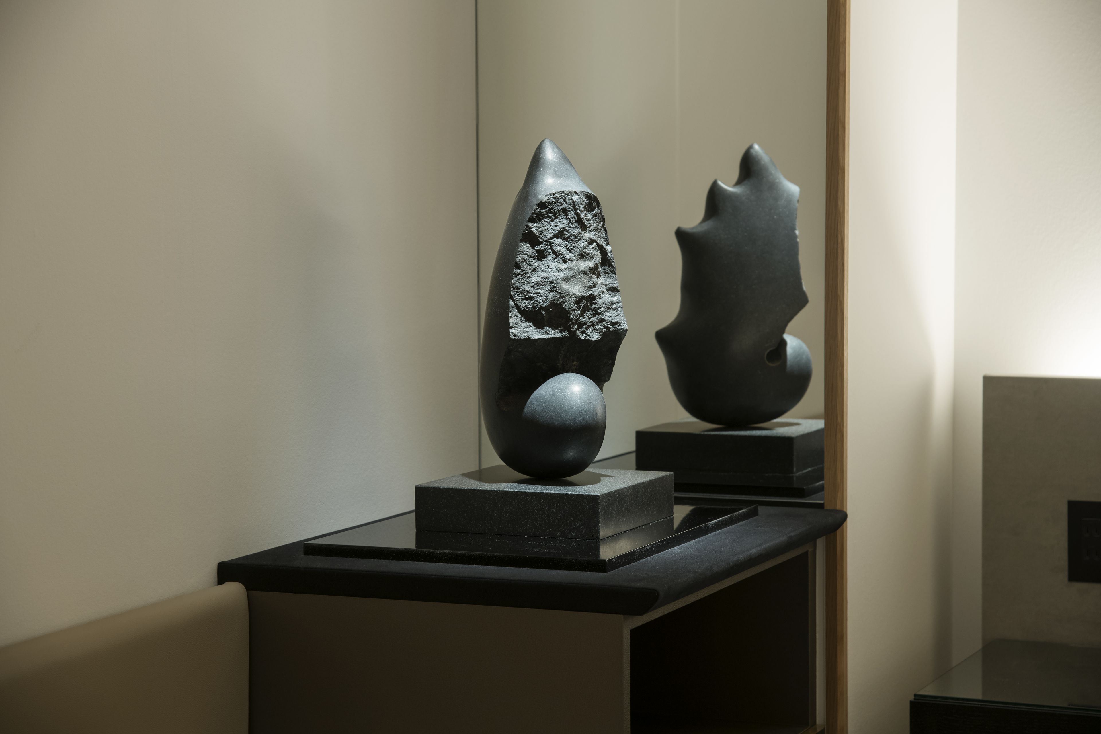 A sculpture on a pedestal in a gallery setting.