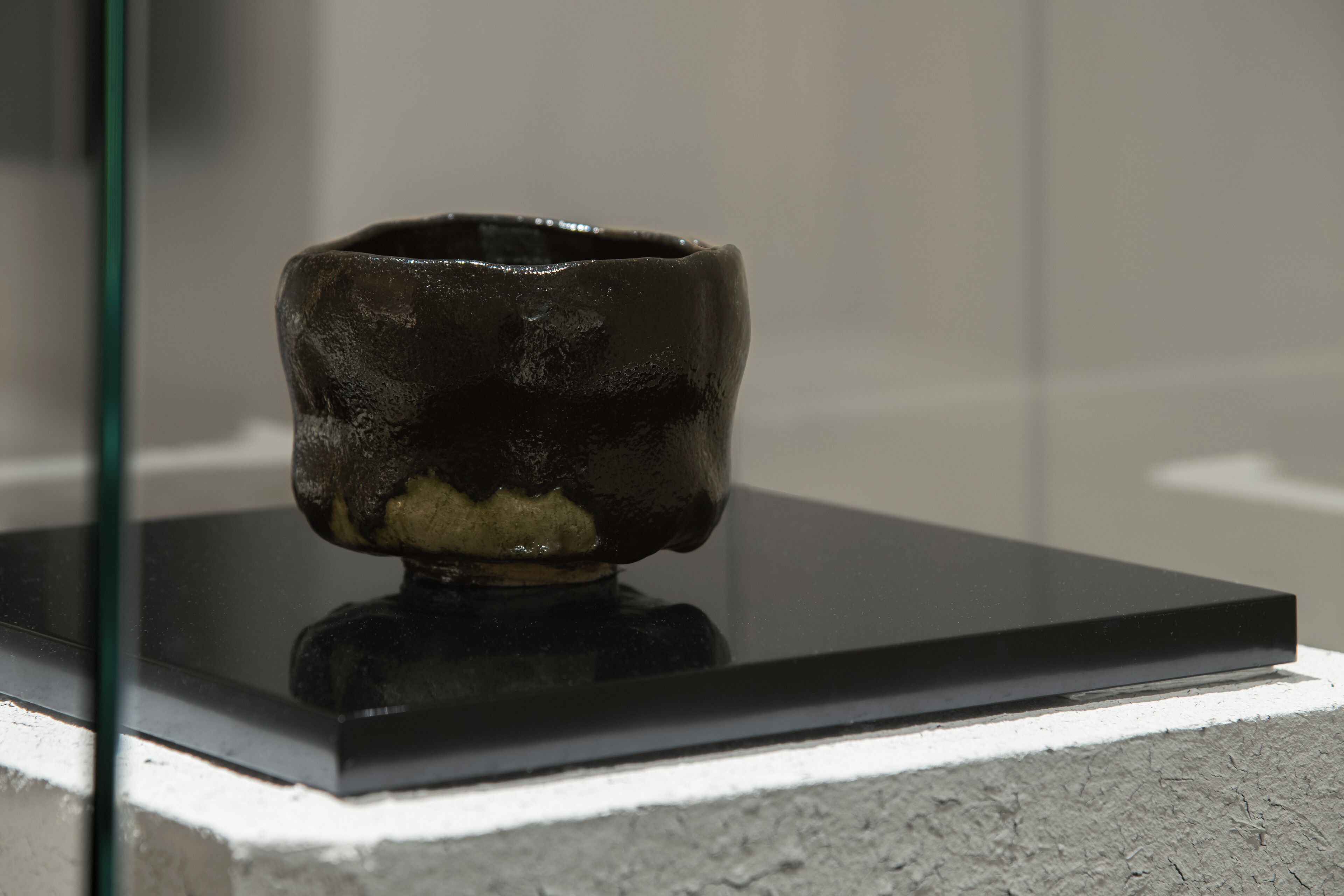 A ceramic bowl on a black platform.
