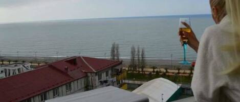 A balcony overlooking a body of water with buildings in the background.