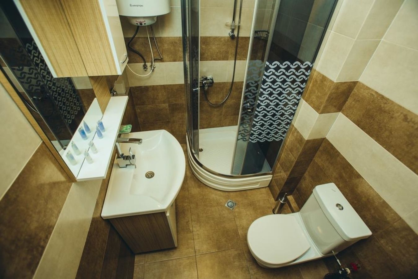 A bathroom with a shower, sink, and toilet.