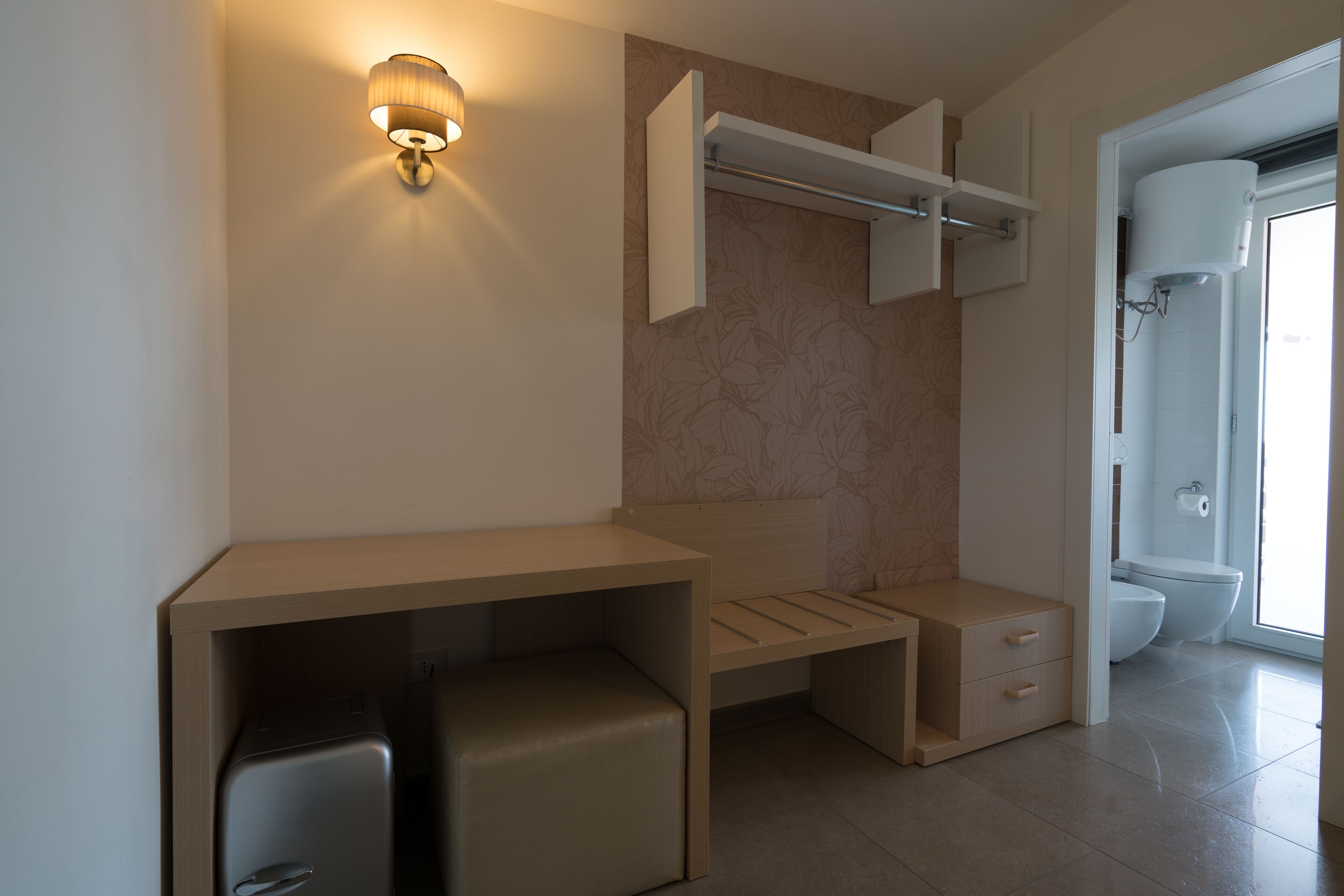 A modern bathroom with a built-in sink, a toilet, and a shower area.