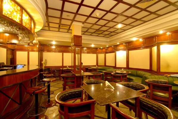 Enjoy a classic dining experience with round tables, booths, and a bar area.