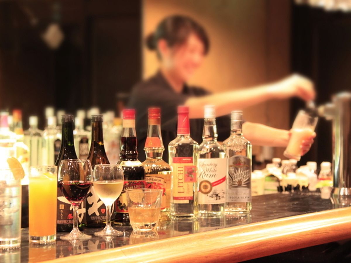 A bar with various bottles and glasses of alcohol.
