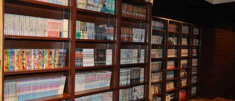 A library with wooden bookshelves filled with books.