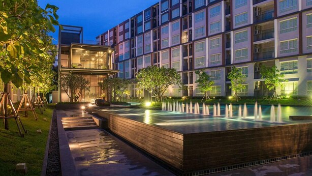 A modern hotel with a rooftop pool, outdoor lighting, and a well-maintained garden. - dcondo mine by BP (Kathu)